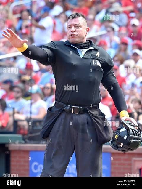 ST. LOUIS, MO - SEPTEMBER 03: Home plate umpire Carlos Torres reacts to shouting from the Pirates' dugout during a MLB game between the Pittsburgh Pirates and the St. Louis Cardinals on