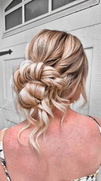 A low, loose bun with a textured crown + soft face-framing pieces., It’s elegant, romantic, and built to last all day!, If you're getting married on a humid or windy day, this is the perfect option, ...