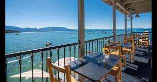 Hammocks hang between pine trees growing on the edge of the sandy beach, where there are blue lounge chairs. Beach Retreat Lodge At Tahoe 218 3 4 7 South Lake Tahoe Hotel Deals Reviews Kayak