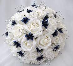 Aside from looking for the perfect dress for your big day, you also have to hunt for that right mix of flowers no peacock feather in this boutonniere but the purple blue orchids with the white rose would look nice for a peacock color theme wedding. Navy Blue Wedding Bouquets Flowers Brides With 4 Bridesmaids Posy Bouquets In Ivor Blue Wedding Bouquet Blue Wedding Flowers Artificial Flowers Wedding