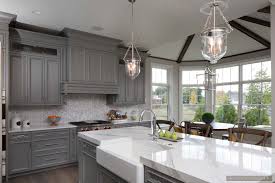 The top cabinets have glass doors for. Inspiring Room Modern Nantucket Style Farmhouse Kitchen With Gray Cabinets Chicago Architectural Photographer