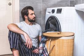 Maybe you would like to learn more about one of these? Handsome Loner Sitting On Floor And Looking At Washing Machine In Bathroom Stock Photo Dissolve