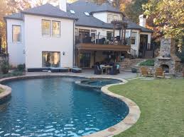 Free Form Pool With Spa And Stone Stacked Outdoor Fireplace Backyard Pool Outdoor Fireplace Freeform Pools