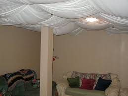 Choose a fabric that complements the room style and use an opaque material such as grass cloth or a backed fabric in the basement. Basement Ceiling Ideas Include Paint Paneling Drop Ceilings And Even Fabric Houselogic Has Idea Basement Ceiling Unfinished Basement Ceiling Fabric Ceiling