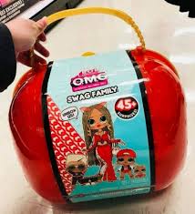 Swag is the omg doll with tan skin, a beauty mark, red nail polish, green eyes, blue eye shadow, red blush, red lipstick, and blonde hair in microbraids. Lol Surprise Omg Swag Family 45 Surprises Top Hottest Toy Reviews 2021