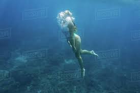 Post gear reviews and generally. Underwater Photo Of Young Woman In Swimming Suit Diving In Ocean Alone Stock Photo Dissolve