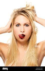 beautiful blonde woman licking chocolate from her lips on white background  Stock Photo - Alamy