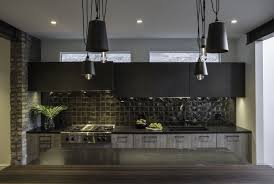 This kitchen with dark kitchen cabinets and a white quartz countertop has a stone mosaic backsplash that fits in perfectly. 25 Beautiful Kitchens With Dark Backsplashes Dark Kitchen Backsplashes