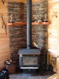 Image Of Wonderful Wood Stove In Small Cabin With Wicker Log Baskets For Fireplaces Corner Wood Stove Wood Burning Stove Corner Wood Stove Hearth