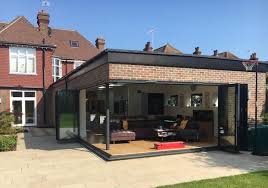Bifold doors offer a transition rom the indoor wooden floorboards to the alternative wooden patio. How To Create The Perfect Kitchen And Dining Area