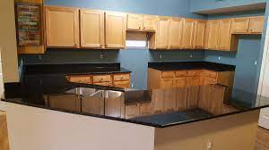 Dark cherry cabinets, uba tuba granite countertops, and neutral colored floor and wall tile. Uba Tuba Granite Countertops Pictures Cost Pros Cons