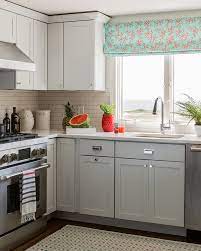 Bottom layer is grey large format porcelain tile, white cabinets are the second layer of the cake, white countertop is like the custard and white subway kitchen backsplash is the topping with black sprinkles (black grout with white subway tiles). Gray Cabinets Contemporary Kitchen Katie Rosenfeld Design