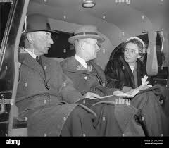 Defense Secretary Robert A. Lovett, left and Assistant Secretaries Charles  Coolidge, center, and Anna Rosenberg leave a conference of top government  officials in Washington late
