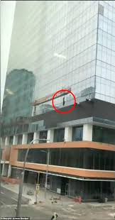 This is how windows are washed on high rise buildings. Horrifying Moment A Window Washer Falls From His Platform In High Winds But Saved By Safety Harness Daily Mail Online