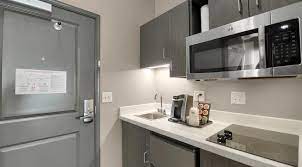 In some motel and hotel rooms, small apartments, college dormitories, or office buildings, a kitchenette consists of a small refrigerator, a microwave oven, and sometimes a sink. 2 Queen Beds Kitchenette Best Western Colorado Springs Hotel