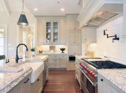 Country Style Galley Kitchen With White Cabinets Farmhouse Sink And Subzero Wolf Range Country Kitchen Designs Kitchen Design Country Kitchen Cabinets