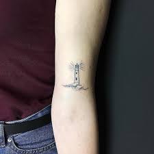 Hand Poked Lighthouse Tattoo On The Left Arm Minimalist Tattoo Lighthouse Tattoo First Tattoo