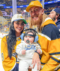 George Kittle and his wife enjoying a night out at the NHL game—sports love  on and off the field! 🏒❤️