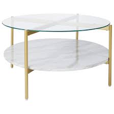 The glass top is crystal clear, and the below shelf storage is an oak wood. Signature Design By Ashley Wynora Gold Finish Round Cocktail Table With Glass Top And Faux Marble Shelf Royal Furniture Cocktail Coffee Tables