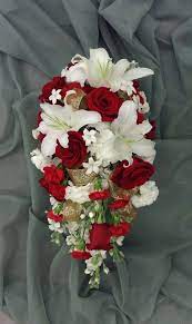 Maybe you would like to learn more about one of these? Red And White Cascading Bridal Bouquet With Red Roses Carnations Lilies Stock Stephanotis And Gold Ri Red Bouquet Wedding Red Bridal Bouquet Bridal Bouquet