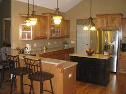 Oak Cabinets Espresso Stained Island Cabinets Light Tan Counter Tops Wood Floor Stainless Kitchen Layout Stainless Steel Kitchen Appliances Kitchen Remodel