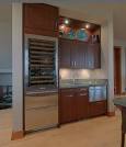 Wet bar with stainless wine and beer fridge black cabinets Before