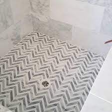 In this bathroom, the round bathtub is clearly the centerpiece. Gray And White Marble Herringbone Floor Tile Design Ideas