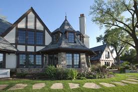 However, the cambria waterfall island and sleek, black barstools speak directly to today. Tudor Style House Tudor Home Architecture Tudor Design Houses