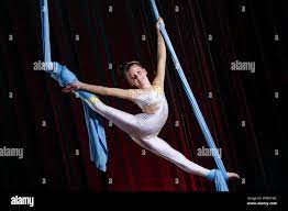 Circus Artist Acrobat Performance On Canvases. The Girl Perform Acrobatic  Elements In The Air Stock Photo - Alamy