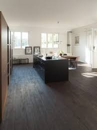 Dark hickory wood floors make an appearance with this particular kitchen, which goes great with the black pendant lights sitting over everything. Dark Floor Kitchens Gallery Kitchen Magazine