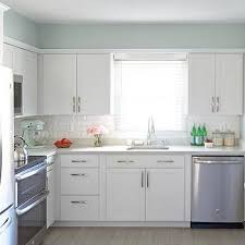 White Kitchen With Gray Wood Like Porcelain Floor Tiles Transitional Kitchen Valspar In 2020 White Kitchen Makeover Classic White Kitchen Paint For Kitchen Walls