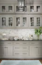 Grey stained wood cabinets look super modern and the black and wood shelving along with the wood panelled ceiling lend this kitchen an industrial feel. Light Gray Butler Pantry Features Glass Front Cabinets With Black Hardware Over Carrera Marble Mini Bric Kitchen Design Black Countertops Grey Kitchen Cabinets