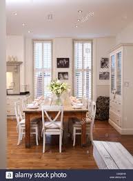 white chairs at simple wood table in
