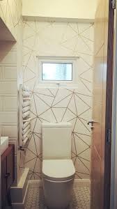 The wallpaper feels organic, almost natural, as if a waterfall had been covered in gold paint. Zara Shimmer Metallic Wallpaper White Gold Bathroom Wallpaper Geometric Wallpaper Living Room White And Gold Wallpaper