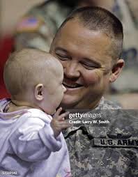 Sergeant Curt Bowman and his wife Sergeant Shelly Bowman hug family... News  Photo
