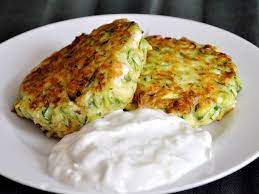 Kolokithokeftedes Greek Zucchini Fritters With Tzatziki Recipe Recipe Tzatziki Recipes Recipes Greek Recipes