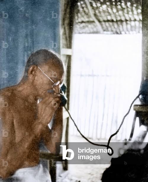 Image of Mahatma Gandhi on telephone, Wardha, 1940 (photo)