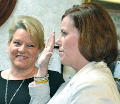 Tiffany Azzinaro is sworn in this afternoon as the new county attorney, as  outgoing county attorney Bobbi Jo Lewis looks on. Azzinaro was sworn in by  Judge-Executive Orbrey Gritton. Lewis, who has