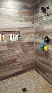 The wood look tile trend is going strong, and we've discovered some amazing design ideas for wood grain effects. Petrified Wood Musk Installed On Shower Wall Shower Wall Petrified Wood Installation