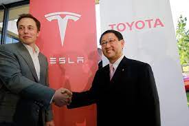 Tesla's Elon Musk and Toyota's Akio Toyoda shaking hands in Palo Alto, CA  cir. 2010. [Credit: Associated Press] - TESLARATI