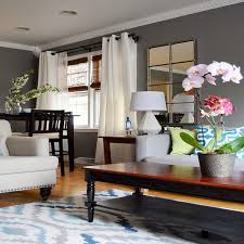 Sculptural wood tables complement leather side chairs and a gray upholstered sofa in a massachusetts living room design crafted by found design studio. Living Room Recessed Lighting Layout