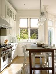 Another important consideration is seating—and whether the space allows for chairs on both sides. Tall Dining Table As Center Island Transitional Kitchen