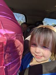 toddler showing off new shoes in store