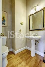 The floor features an intricate herringbone pattern of rectangular tiles, bordered in black, white, and gray. Light Grey Bathroom With White Washbasin Stand Stock Photos Freeimages Com