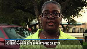 Students, parents rally around Bryan band director at district meeting