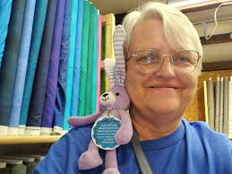 Does anyone recognize the crochet frog seller at Frog Follies?