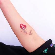 Color tattoo of an ocean pearl with ariel from the little mermaid and crush the baby turtle in finding nemo. Ariel Tattoo On The Inner Forearm