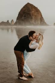 The Cutest Adventurous Couples Session On Cannon Beach Look At That View Of Haystack Rock I Love The Oregon Coast Clic Couple Photography Photo Couple Beach