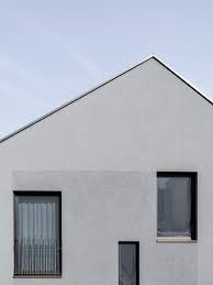 Several Irregularly Sized Windows Punctuate The East Facade Directing Inhabitants Views Towards Different Pa Minimalist Architecture Architecture Swiss House