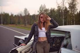 Wallpaper : Eva Lunichkina, model, brunette, long hair, women with cars,  hair in face, sunglasses, looking at viewer, leather jackets, jacket, black  jackets, Crop Top, white tops, belly, pierced navel, jeans, road,